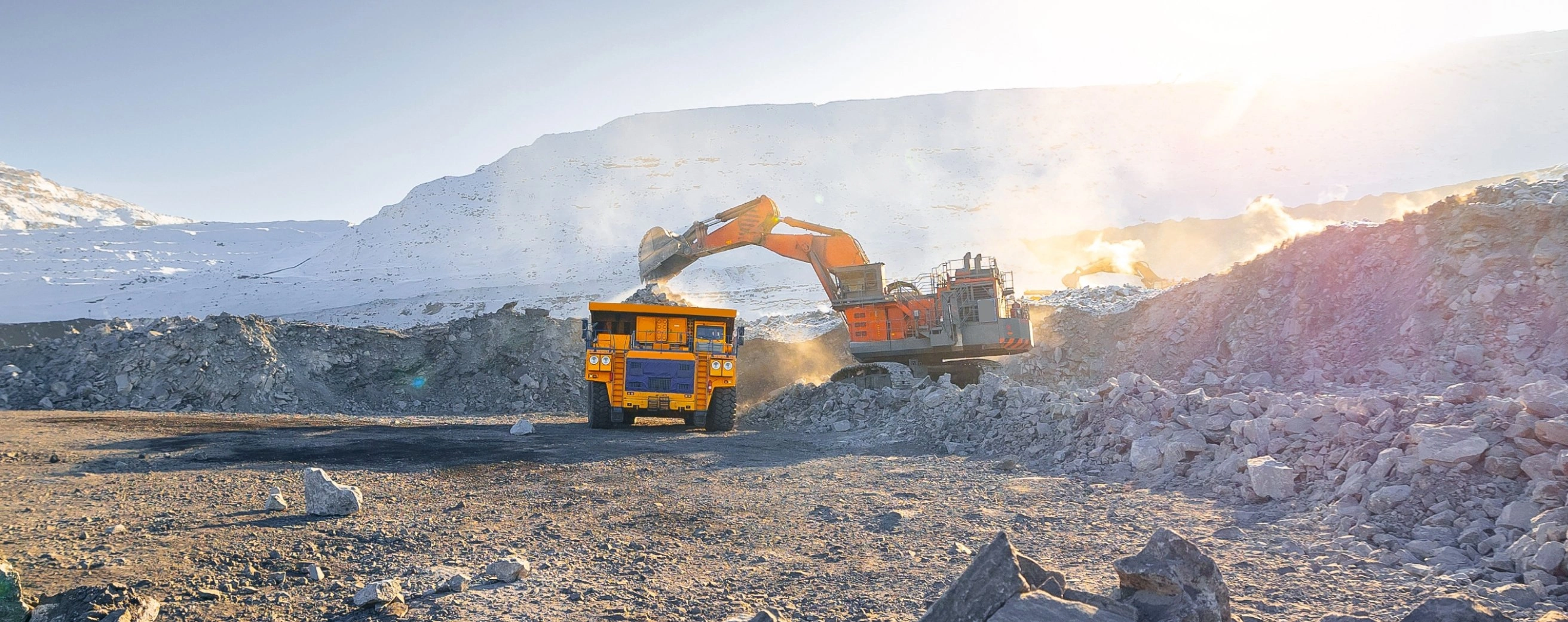 Excavator loading a haul truck at an open-pit mine